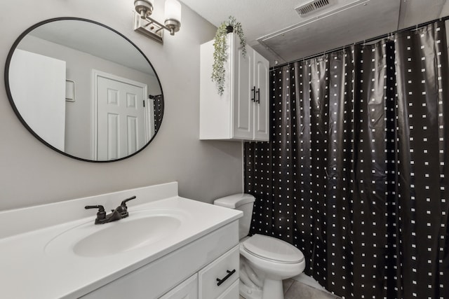 bathroom with visible vents, toilet, vanity, a shower with curtain, and tile patterned floors