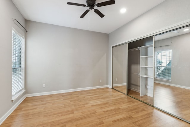 unfurnished bedroom with baseboards, a ceiling fan, light wood-type flooring, a closet, and recessed lighting