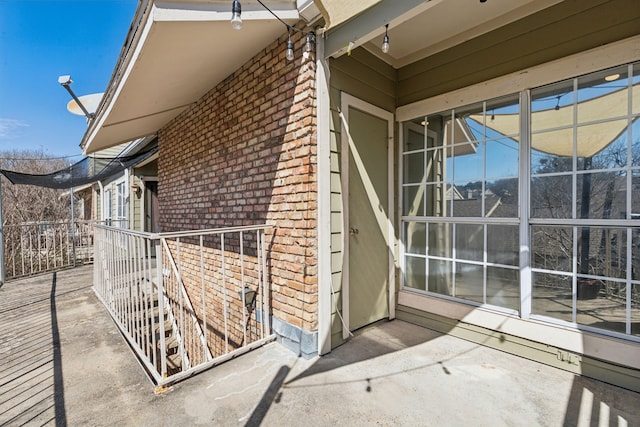 view of side of home with brick siding