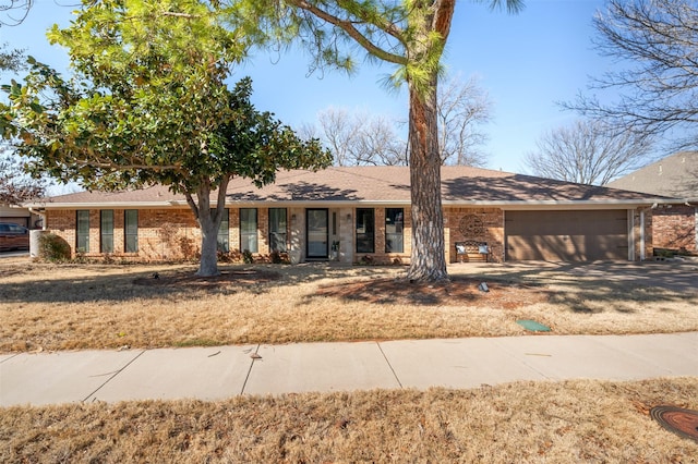 single story home with brick siding and an attached garage