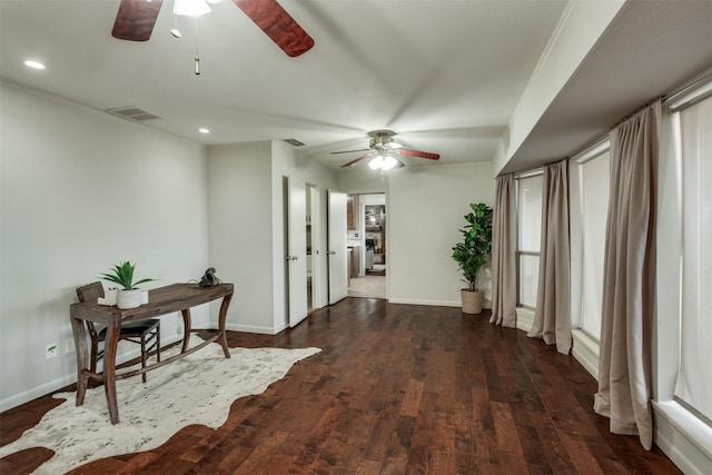 hallway with visible vents, baseboards, and wood finished floors