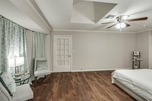 bedroom featuring ornamental molding, wood finished floors, visible vents, and baseboards