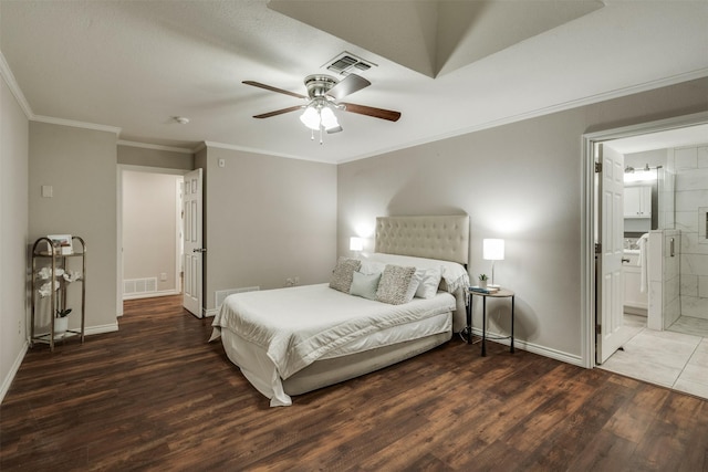 bedroom featuring wood finished floors, visible vents, and baseboards