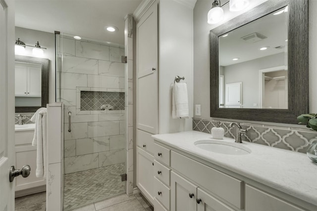 full bath featuring vanity, a shower stall, visible vents, and recessed lighting