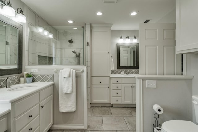 full bathroom with toilet, recessed lighting, a sink, tasteful backsplash, and a stall shower