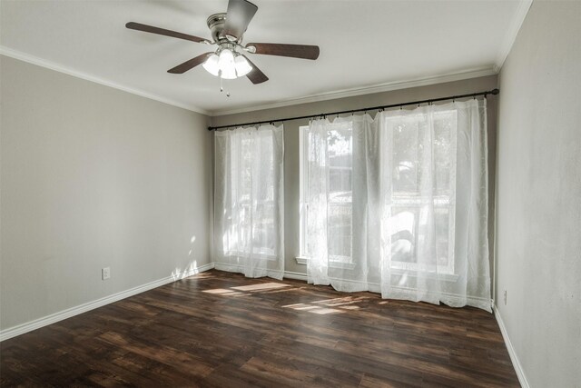 spare room featuring crown molding, baseboards, and wood finished floors