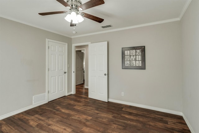 unfurnished bedroom featuring ornamental molding, dark wood-style flooring, and visible vents