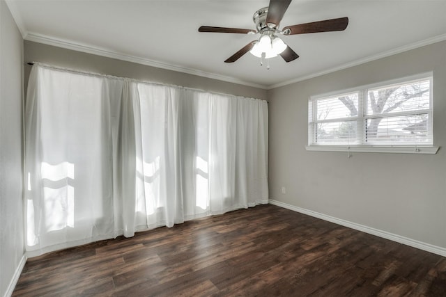 empty room featuring baseboards, dark wood finished floors, and crown molding