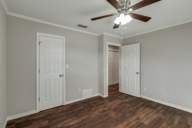 unfurnished bedroom with crown molding, wood finished floors, visible vents, and baseboards