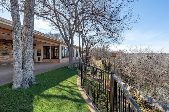 view of yard featuring fence and a patio