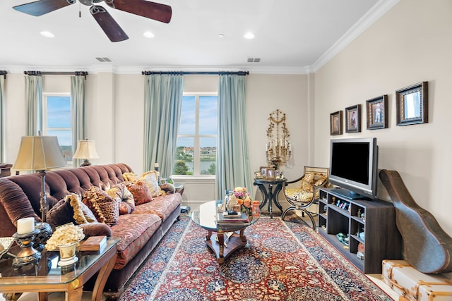 living area with visible vents, crown molding, and recessed lighting