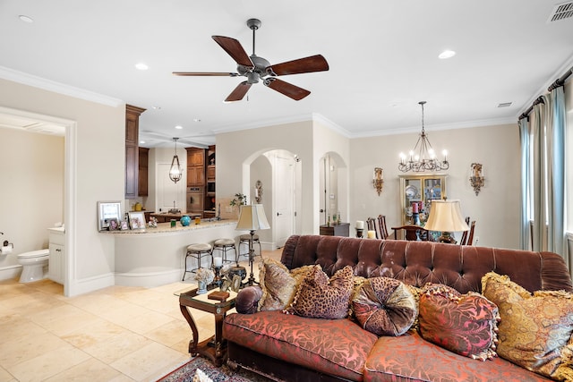 living area featuring arched walkways, visible vents, crown molding, and ceiling fan with notable chandelier