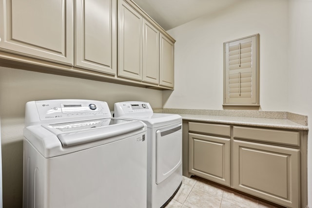 laundry room with washer and dryer, cabinet space, and light tile patterned flooring