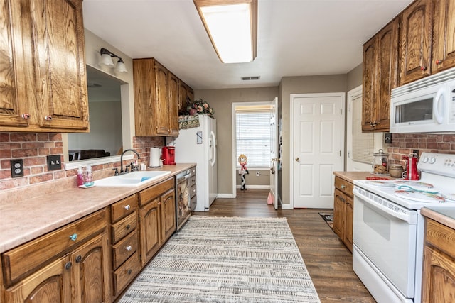 2317 Jodi Ln, Gainesville, TX 76240 - kitchen featuring white appliances, a sink, decorative backsplash, light countertops, and brown cabinets