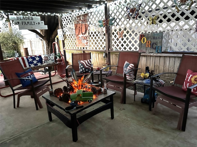 view of patio / terrace with an outdoor living space with a fire pit and fence