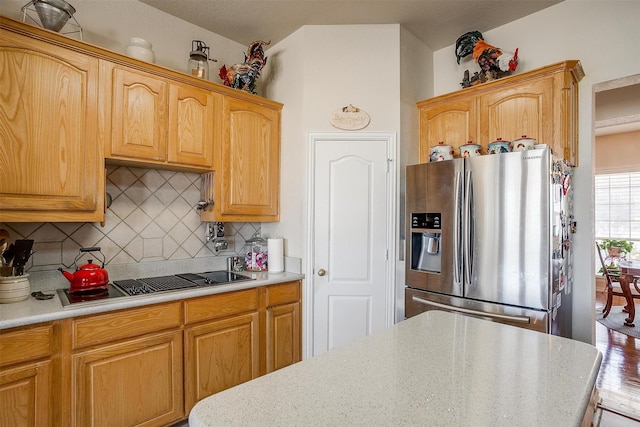 kitchen with stainless steel appliances, light countertops, and tasteful backsplash