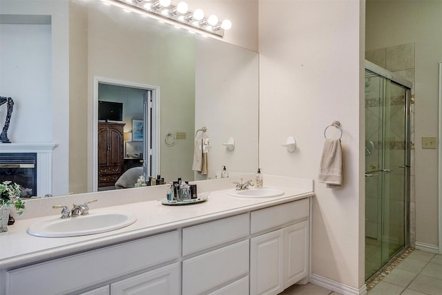 ensuite bathroom with double vanity, a sink, a shower stall, and ensuite bathroom