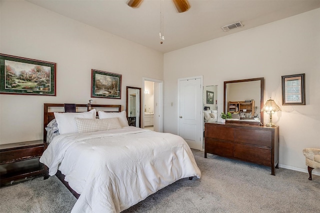 bedroom with visible vents, ensuite bathroom, a ceiling fan, carpet flooring, and baseboards