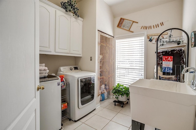 laundry room with cabinet space, a sink, washer and clothes dryer, and light tile patterned floors