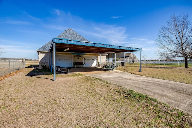 exterior space with a garage, a front yard, and fence