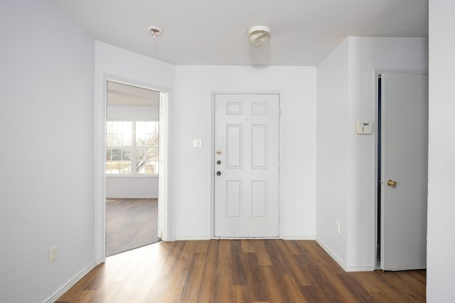 entrance foyer featuring baseboards and wood finished floors