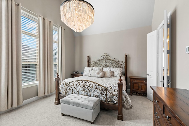 bedroom featuring light carpet and a notable chandelier