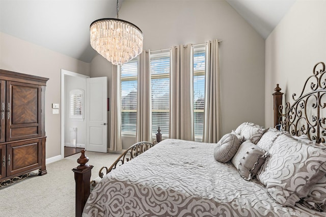 carpeted bedroom featuring a chandelier, baseboards, and vaulted ceiling