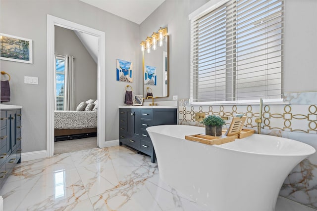 bathroom featuring a soaking tub, marble finish floor, connected bathroom, and vanity