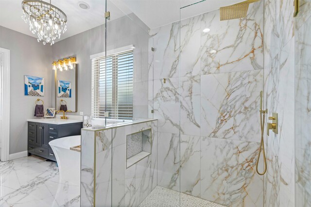 full bathroom featuring a freestanding bath, vanity, a chandelier, a marble finish shower, and marble finish floor