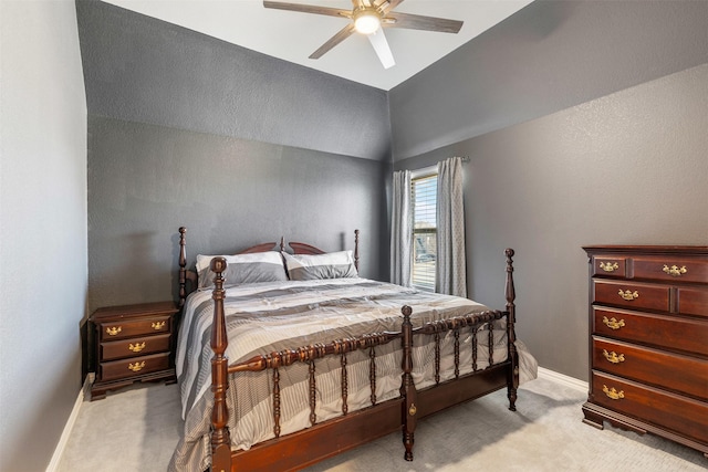 bedroom with baseboards, a ceiling fan, lofted ceiling, and light carpet