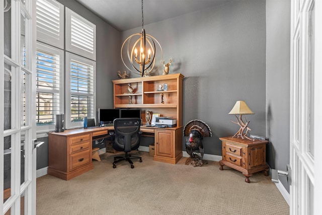 home office featuring light carpet, baseboards, and a notable chandelier