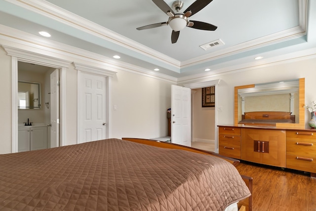 bedroom featuring recessed lighting, a raised ceiling, visible vents, and wood finished floors