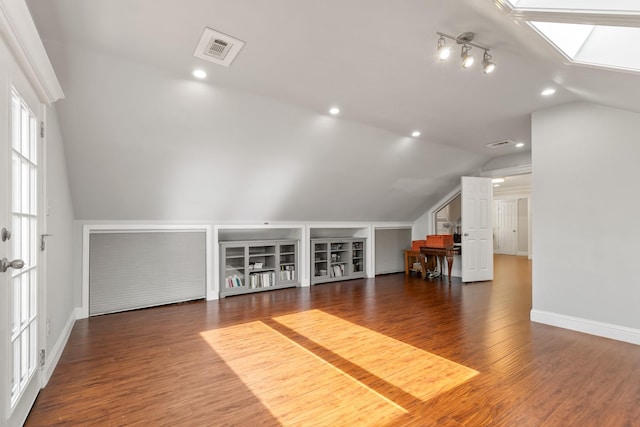 bonus room with lofted ceiling with skylight, visible vents, wood finished floors, and recessed lighting