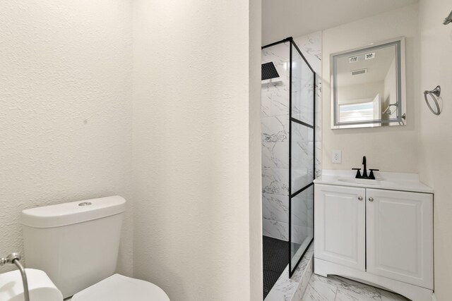 full bathroom with marble finish floor, a marble finish shower, visible vents, toilet, and vanity