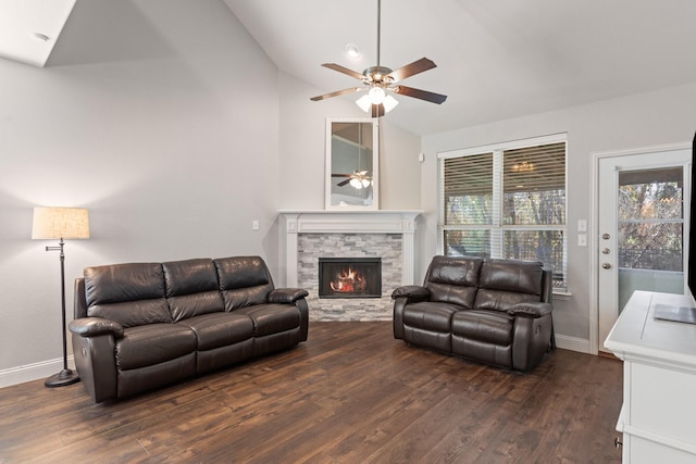 living room with baseboards, a ceiling fan, wood finished floors, vaulted ceiling, and a fireplace