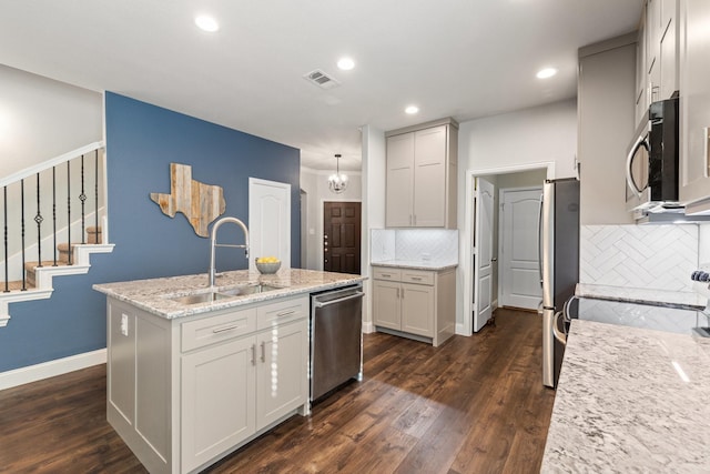 kitchen featuring dark wood-type flooring, visible vents, stainless steel appliances, and a sink