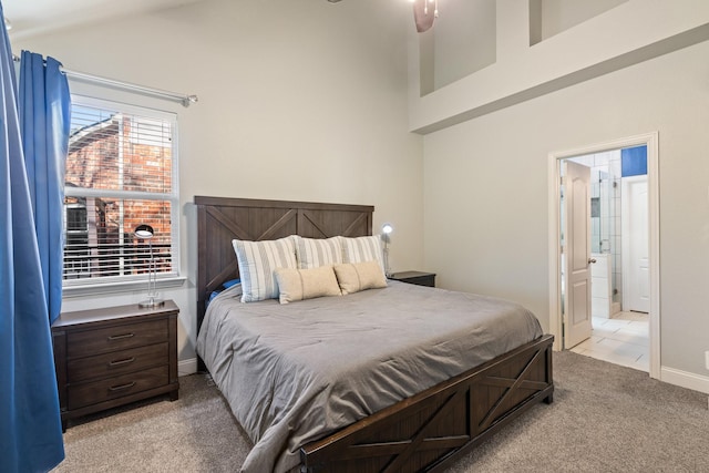 bedroom featuring carpet, lofted ceiling, connected bathroom, tile patterned flooring, and baseboards