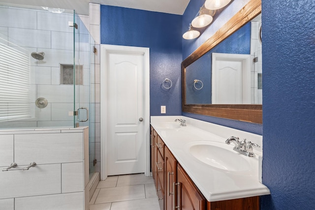 full bathroom featuring a stall shower, tile patterned flooring, a sink, and double vanity