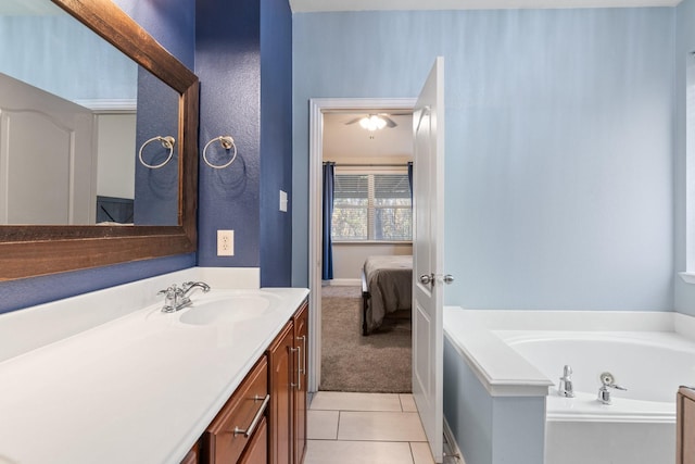 ensuite bathroom with tile patterned floors, ensuite bath, a garden tub, and vanity