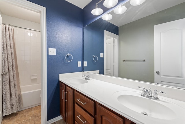 bathroom with double vanity, shower / bath combo with shower curtain, and a sink