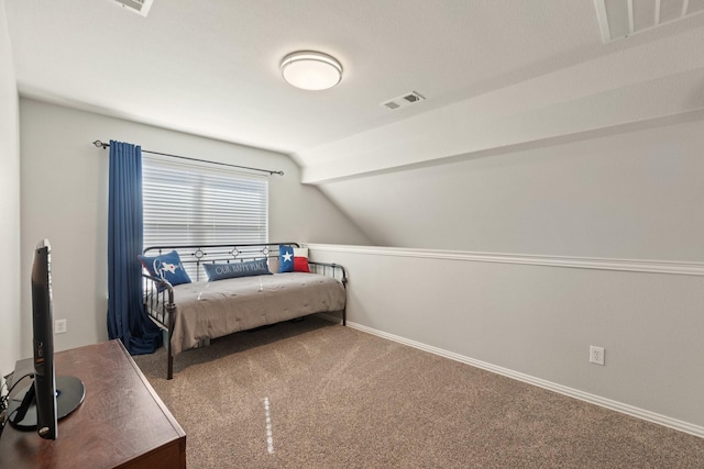 carpeted bedroom featuring lofted ceiling, visible vents, and baseboards