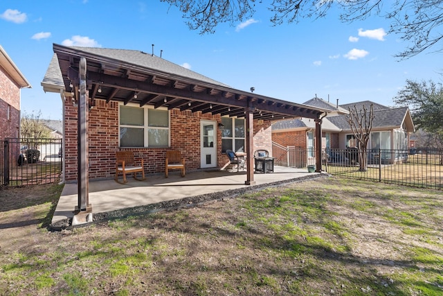 back of house with fence, a patio, and brick siding