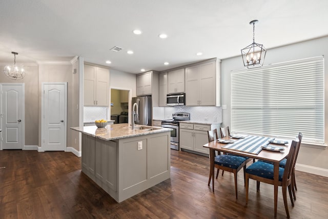 kitchen featuring a notable chandelier, stainless steel appliances, tasteful backsplash, visible vents, and dark wood-type flooring