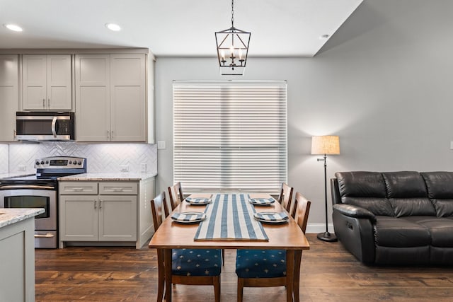 dining area with baseboards, dark wood-style flooring, and recessed lighting