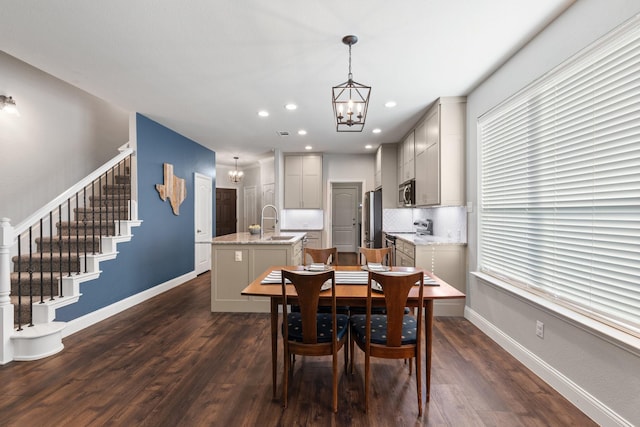 dining space with a chandelier, stairway, baseboards, and dark wood-style floors