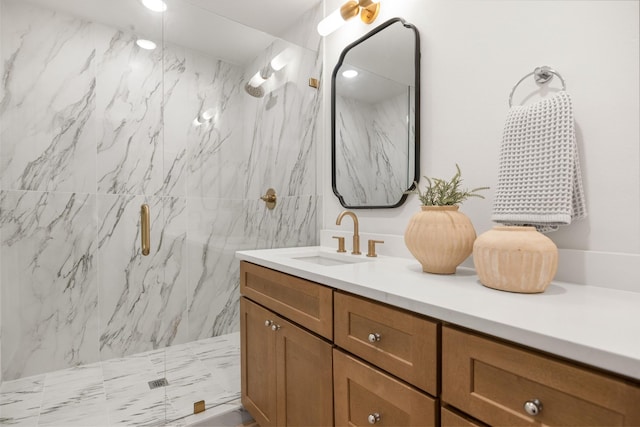 full bathroom featuring a marble finish shower and vanity