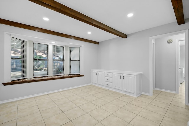 unfurnished room with baseboards, beam ceiling, and recessed lighting