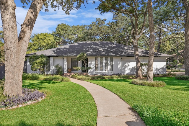 view of front of house with brick siding and a front yard