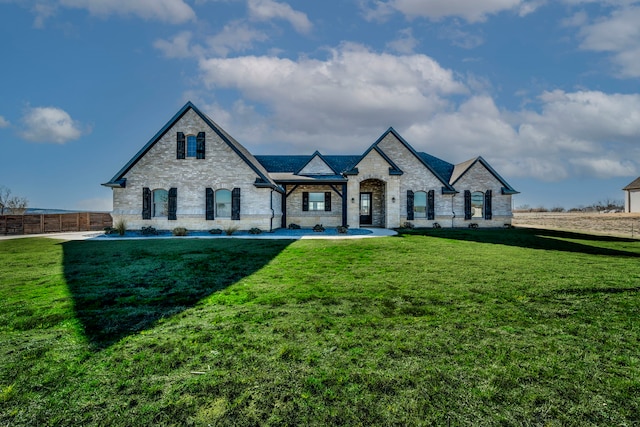 french provincial home with fence and a front lawn