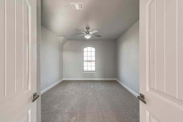 unfurnished room featuring ceiling fan, carpet flooring, visible vents, and baseboards